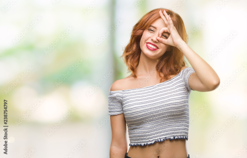 Young beautiful woman over isolated background doing ok gesture with hand smiling, eye looking through fingers with happy face. Young beautiful woman over isolated background doing ok gesture with hand smiling, eye looking through fingers with happy face.