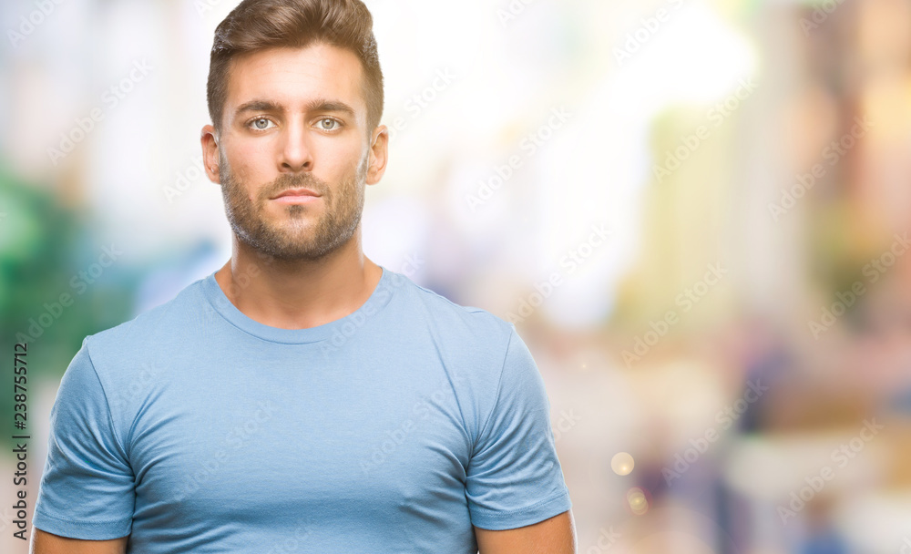 Young handsome man over isolated background with serious expression on face. Simple and natural looking at the camera. Young handsome man over isolated background with serious expression on face. Simple and natural looking at the camera.