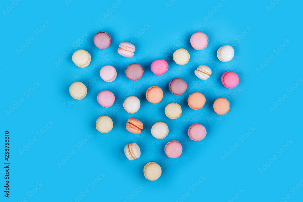 Cake macaron or macaroon on blue background., flavor almond cookies, pastel colors, vintage card. Heart. Cake macaron or macaroon on blue background., flavor almond cookies, pastel colors, vintage card. Heart.