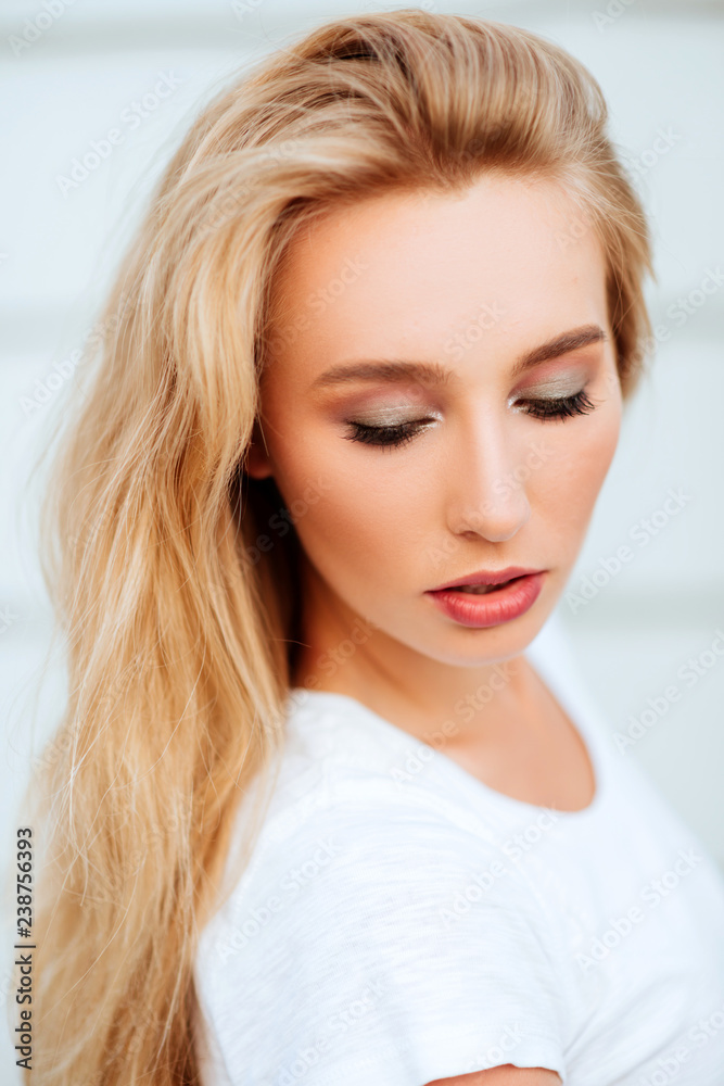 Portrait of blond young woman posing outdoors. Lifestyle Portrait of blond young woman posing outdoors. Lifestyle