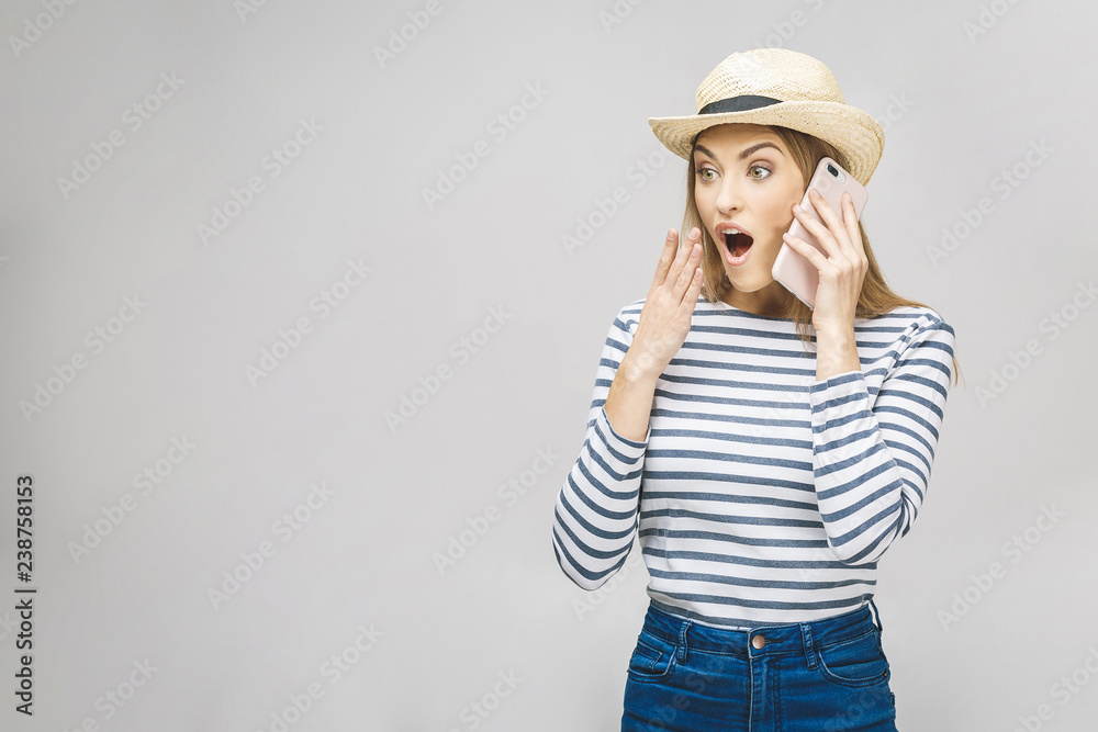 Oh no! Really?! Young brunette lady standing isolated over white background, using mobile phone, wearing casual shirt. Oh no! Really?! Young brunette lady standing isolated over white background, using mobile phone, wearing casual shirt.