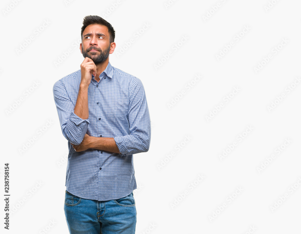 Adult hispanic man over isolated background with hand on chin thinking about question, pensive expression. Smiling with thoughtful face. Doubt concept. Adult hispanic man over isolated background with hand on chin thinking about question, pensive expression. Smiling with thoughtful face. Doubt concept.