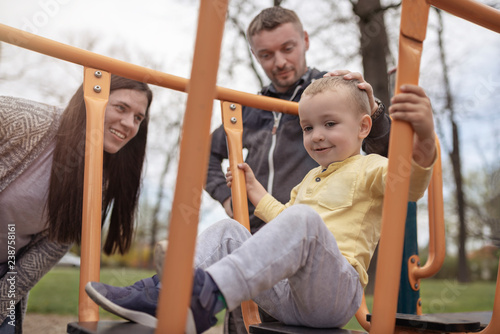 Parents spending their free time with their child in nature on sunny day