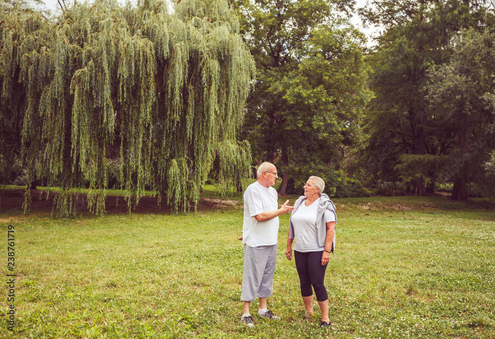 Senior exercise - Senior couple enjoying a moment and talking together.