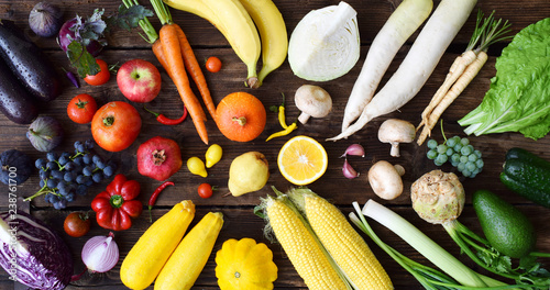 Fototapeta Naklejka Na Ścianę i Meble -  White, yellow, green, orange, red, purple fruits and vegetables on wooden background.  Healthy food. Multicolored raw food.