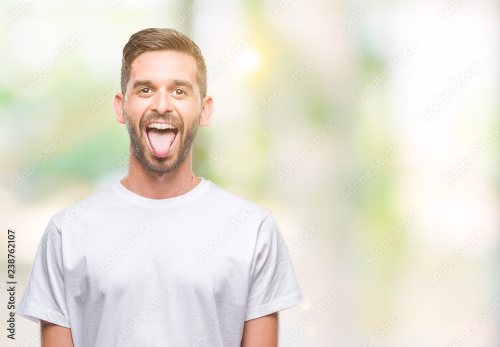 Young handsome man over isolated background sticking tongue out happy with funny expression. Emotion concept. Young handsome man over isolated background sticking tongue out happy with funny expression. Emotion concept.