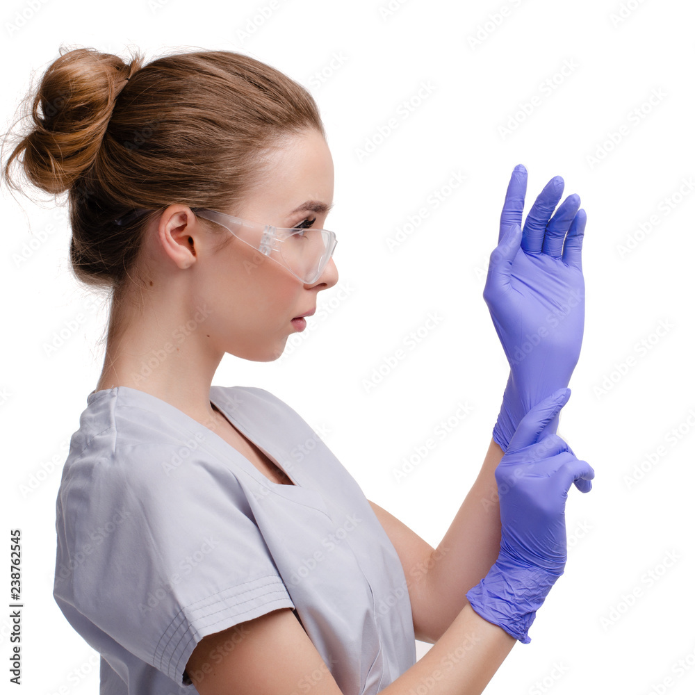 Beautiful female doctor or nurse wearing protective glasses, putting on  latex or rubber gloves on white background isolated. Health care concept  Stock Photo | Adobe Stock