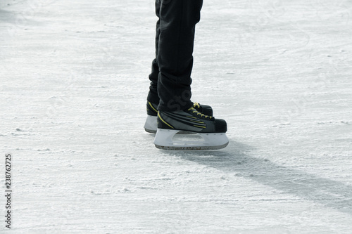 man skating during the Christmas holidays, ice skating, feet in snow, 