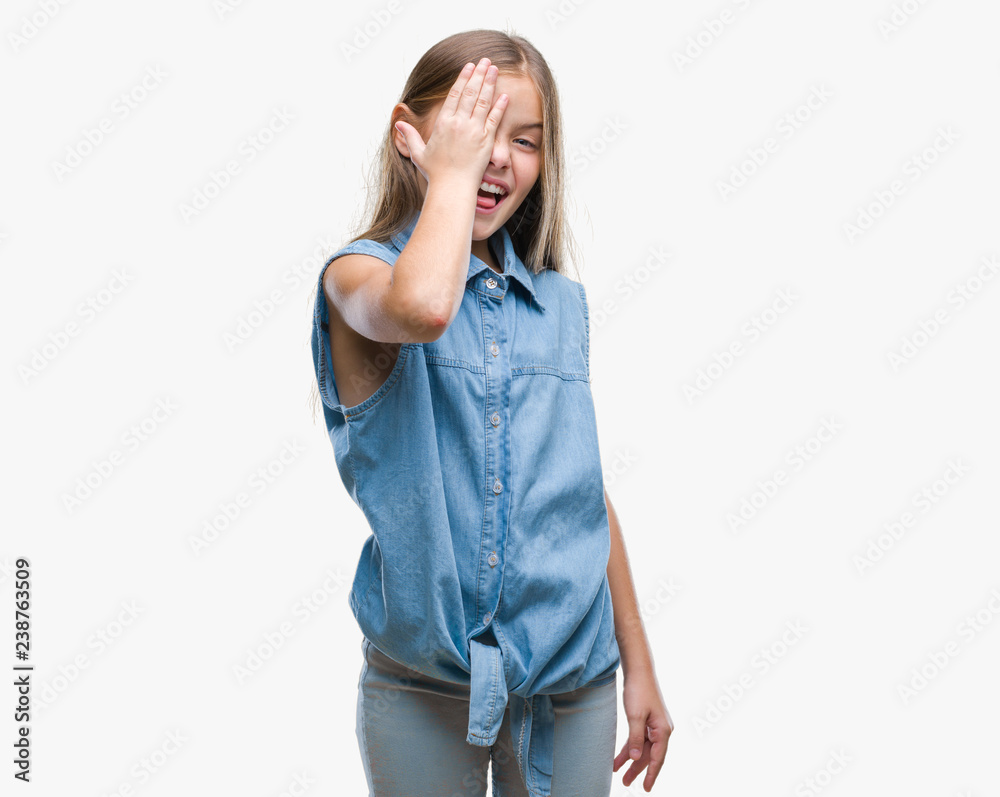 Young beautiful girl over isolated background covering one eye with hand with confident smile on face and surprise emotion. Young beautiful girl over isolated background covering one eye with hand with confident smile on face and surprise emotion.