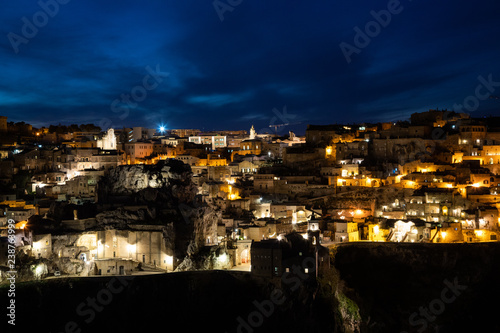 Panorama of Matera and Gravina by night seen from the archaeological park of the Murge Materane, Basilicata, Italy