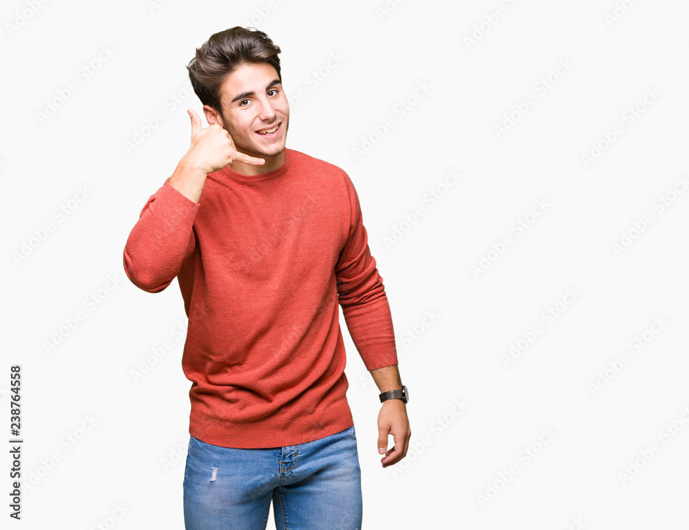 Young handsome man over isolated background smiling doing phone gesture with hand and fingers like talking on the telephone. Communicating concepts. Young handsome man over isolated background smiling doing phone gesture with hand and fingers like talking on the telephone. Communicating concepts.
