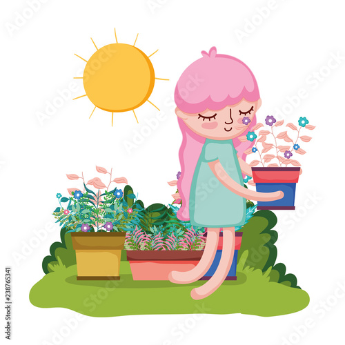 little girl lifting houseplant in the garden