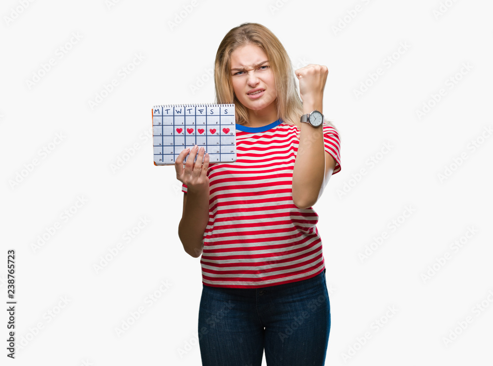 Young caucasian woman holding menstruation calendar over isolated background annoyed and frustrated shouting with anger, crazy and yelling with raised hand, anger concept Young caucasian woman holding menstruation calendar over isolated background annoyed and frustrated shouting with anger, crazy and yelling with raised hand, anger concept