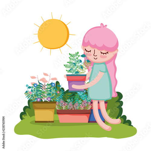 little girl lifting houseplant in the garden