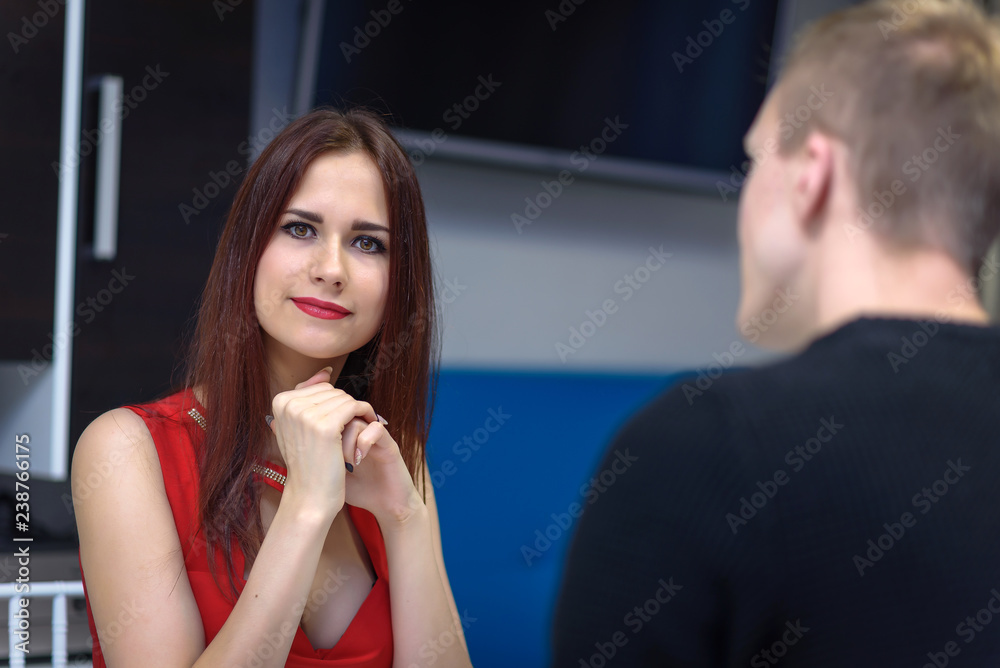 lovers sit at the table and the woman looks at the guy