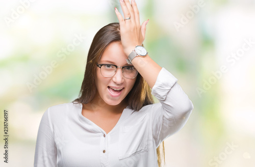 Young caucasian beautiful business woman wearing glasses over isolated background surprised with hand on head for mistake, remember error. Forgot, bad memory concept.