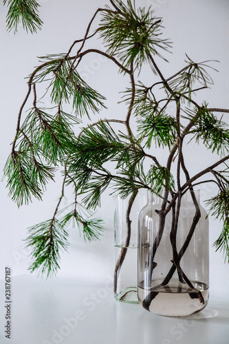 Scandinavian Christmas decor. pine branches and a ceramic house