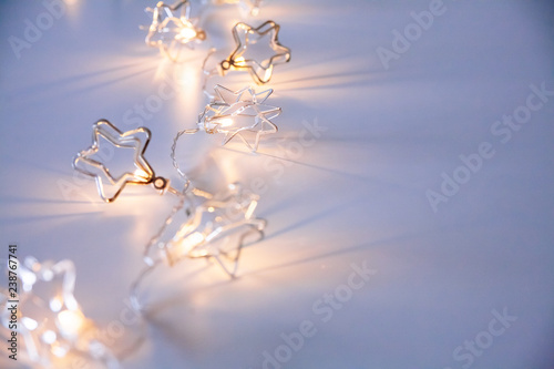 A stars shaped christmass garland on the table. Space for text