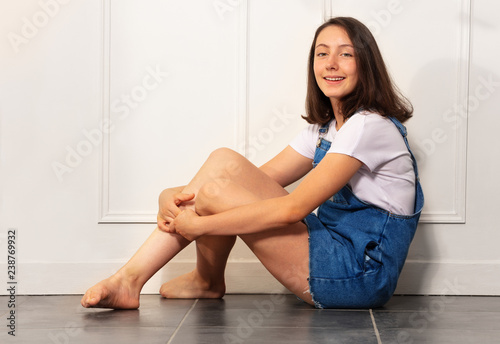 Portrait of girl teenager sitting on the floor