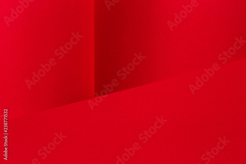Abstract geometric paper textured red background.