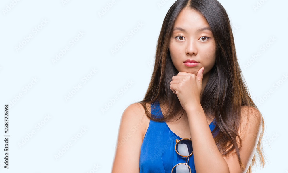 Young asian woman over isolated background looking confident at the camera with smile with crossed arms and hand raised on chin. Thinking positive. Young asian woman over isolated background looking confident at the camera with smile with crossed arms and hand raised on chin. Thinking positive.