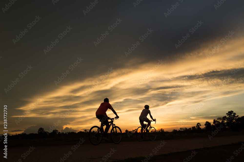 silhouette of cyclist on background of sunset silhouette of cyclist on background of sunset