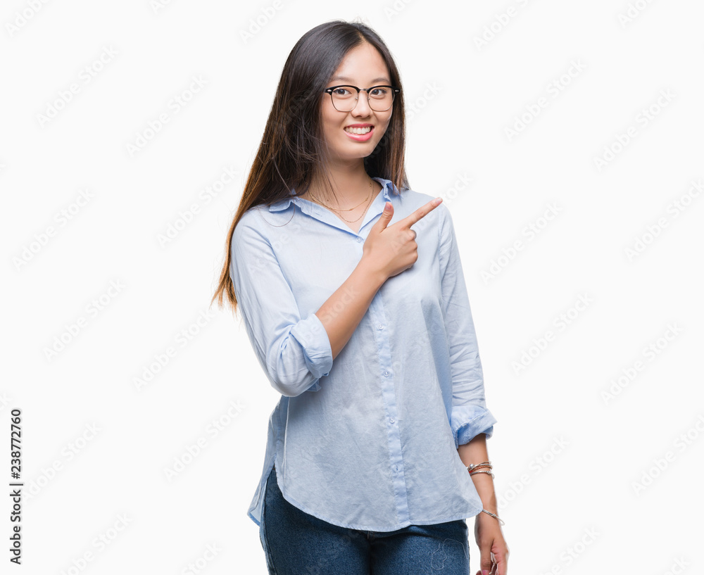 Young asian business woman wearing glasses over isolated background cheerful with a smile of face pointing with hand and finger up to the side with happy and natural expression on face Young asian business woman wearing glasses over isolated background cheerful with a smile of face pointing with hand and finger up to the side with happy and natural expression on face