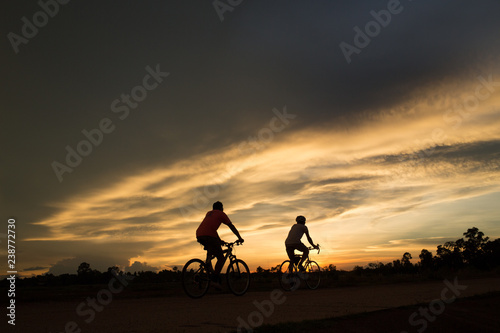 silhouette of cyclist on background of sunset