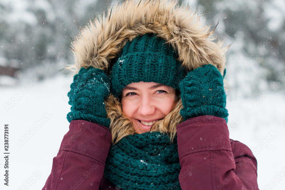 portrait of a young woman in a hood in a snowy forest portrait of a young woman in a hood in a snowy forest