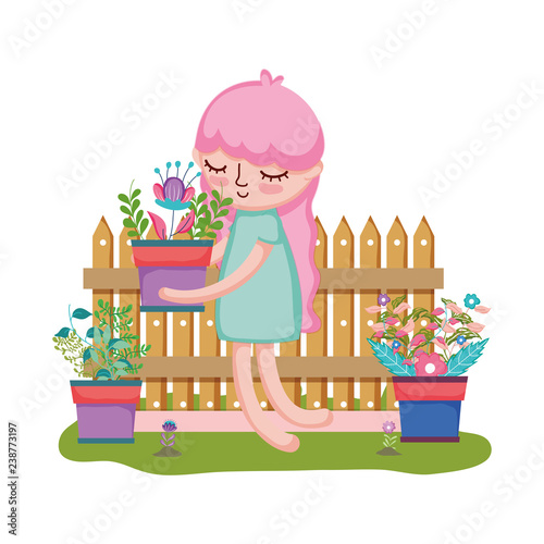 girl lifting houseplant with fence in the garden