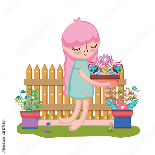 girl lifting houseplant with fence in the garden