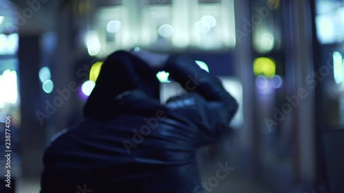 mcdonalds street city man in hood with shaved head shopping at night