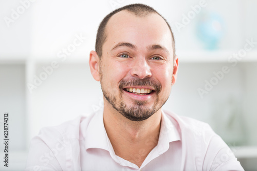 Positive young man in office