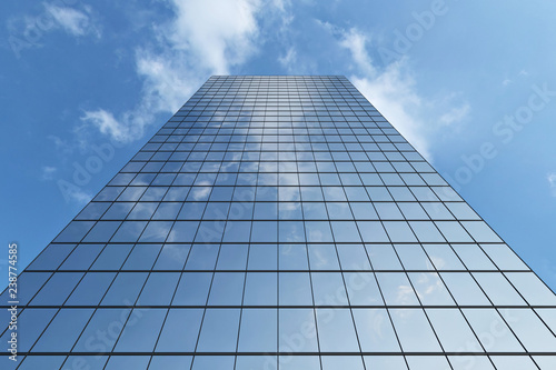 Modern skyscraper under blue sky with clouds