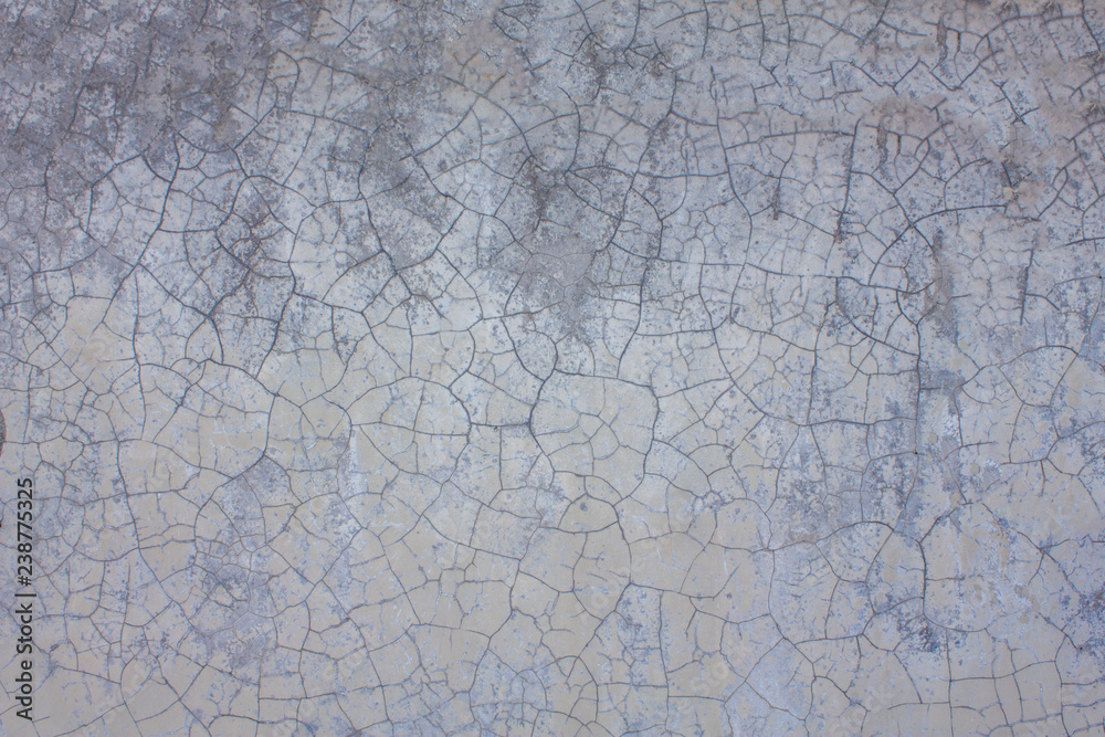 Old white gray purple wall with cracks and stains of dirt. rough surface texture