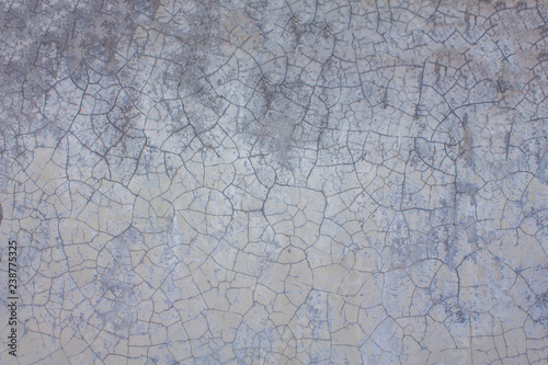 Old white gray purple wall with cracks and stains of dirt. rough surface texture