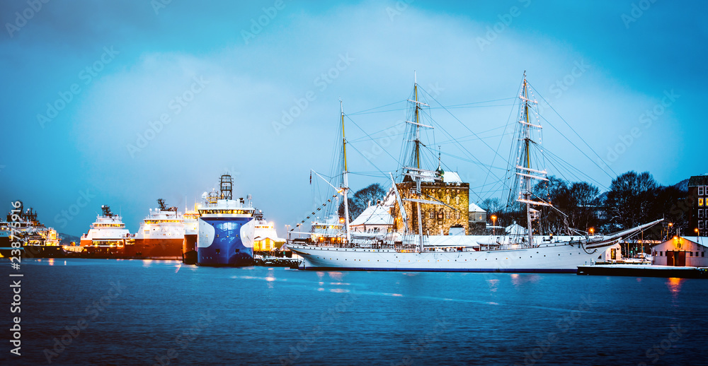 Vessels docked in harbor in Bergen, Norway. Evening view of the port of Bergen