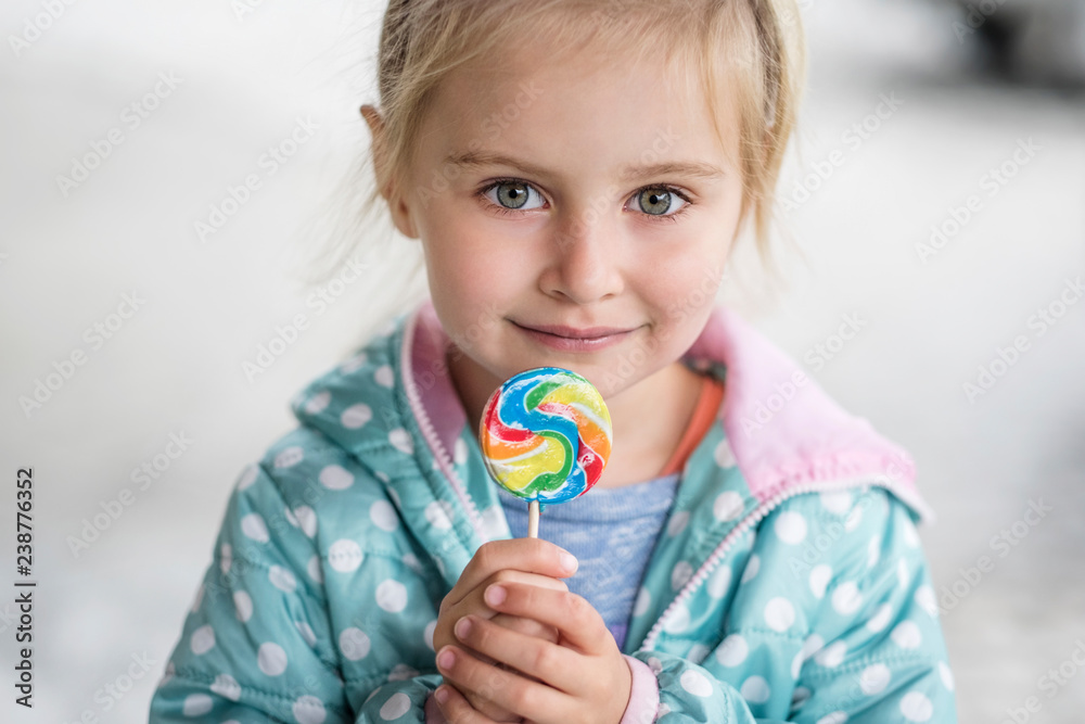 Cute little girl with candy, outdoor Cute little girl with candy, outdoor