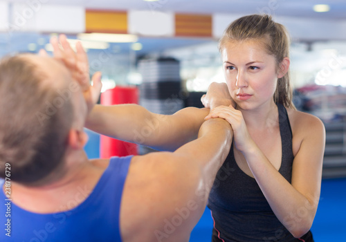 Happy woman is fighting with trainer