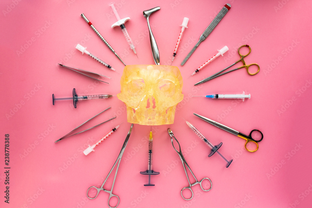 Flat lay of medical instruments with human skull on rose background. Mock up health care medical background. Flat lay of medical instruments with human skull on rose background. Mock up health care medical background.