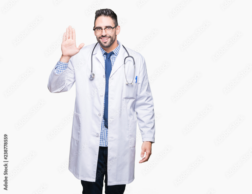 Handsome young doctor man over isolated background Waiving saying hello happy and smiling, friendly welcome gesture Handsome young doctor man over isolated background Waiving saying hello happy and smiling, friendly welcome gesture