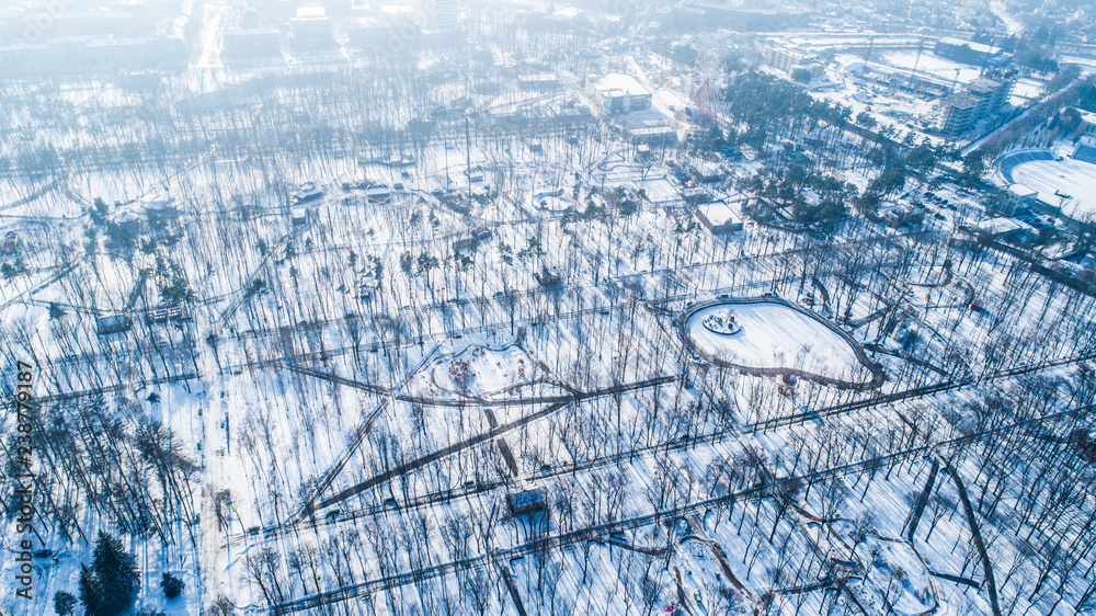 Top view of central city park during winter with snow. Aerial view of winter urban park with no people