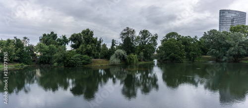 Summer park with lake and clouds