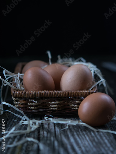 chicken eggs in a purse on a dark background. Low key. Rustic. Close up, selective focus. Copy space