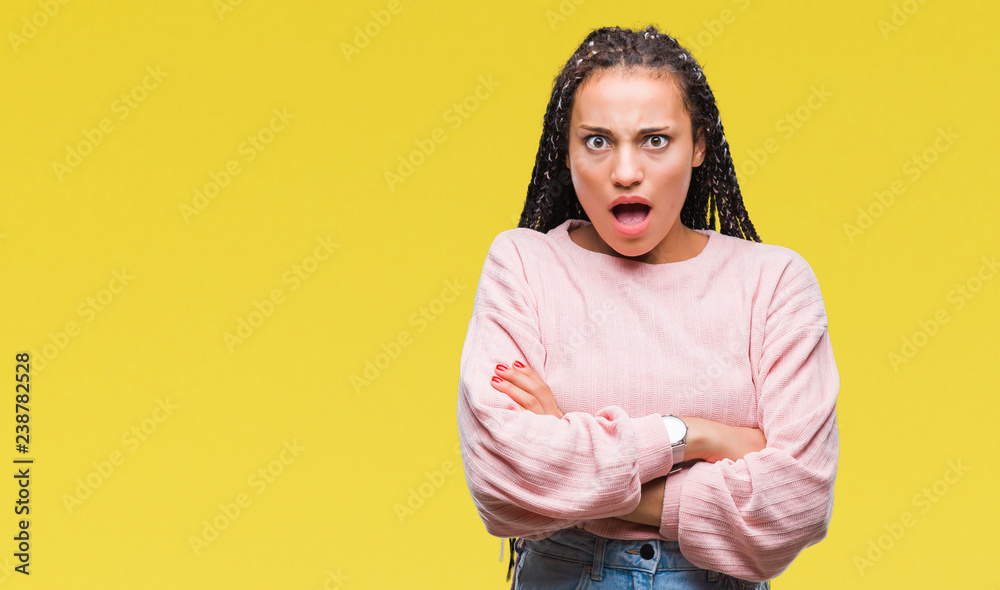 Young braided hair african american girl wearing sweater over isolated background afraid and shocked with surprise expression, fear and excited face. Young braided hair african american girl wearing sweater over isolated background afraid and shocked with surprise expression, fear and excited face.