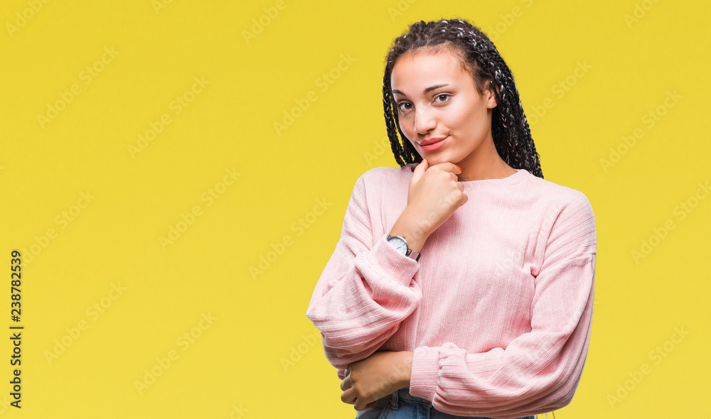 Young braided hair african american girl wearing sweater over isolated background looking confident at the camera with smile with crossed arms and hand raised on chin. Thinking positive. Young braided hair african american girl wearing sweater over isolated background looking confident at the camera with smile with crossed arms and hand raised on chin. Thinking positive.