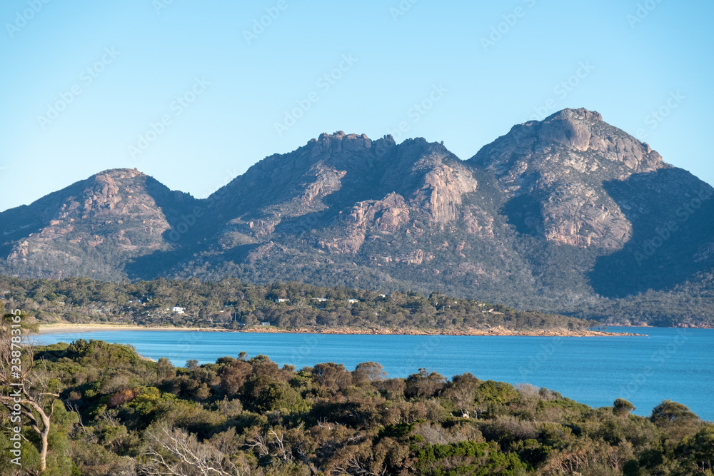 The Hazard Mountains in Freycinet National Park, Tasmania, Australia seen from Coles Bay on a sunny summer day