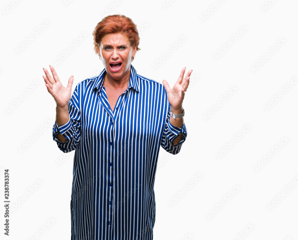Atrractive senior caucasian redhead woman over isolated background celebrating mad and crazy for success with arms raised and closed eyes screaming excited. Winner concept Atrractive senior caucasian redhead woman over isolated background celebrating mad and crazy for success with arms raised and closed eyes screaming excited. Winner concept
