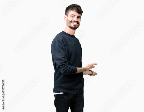 Young handsome man over isolated background Inviting to enter smiling natural with open hand