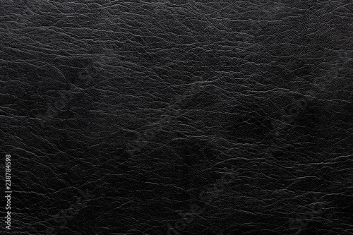 Creased, black imitation leather. Texture for background and design.